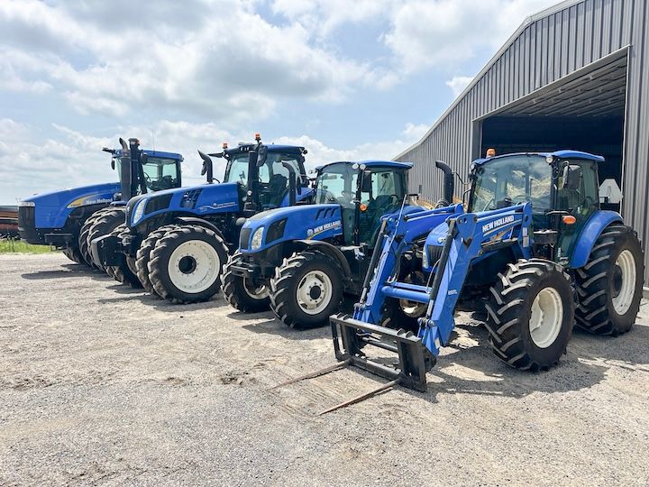 Lineup of Blue New Holland Tractors
